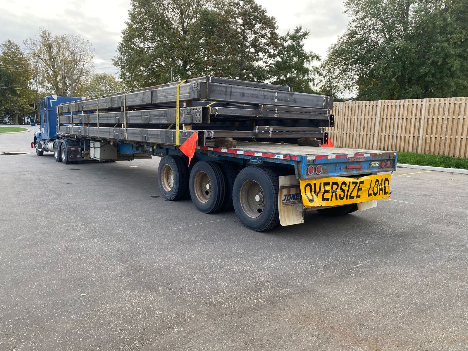 Novalight quad-axle flatbed carrying an oversize steel load