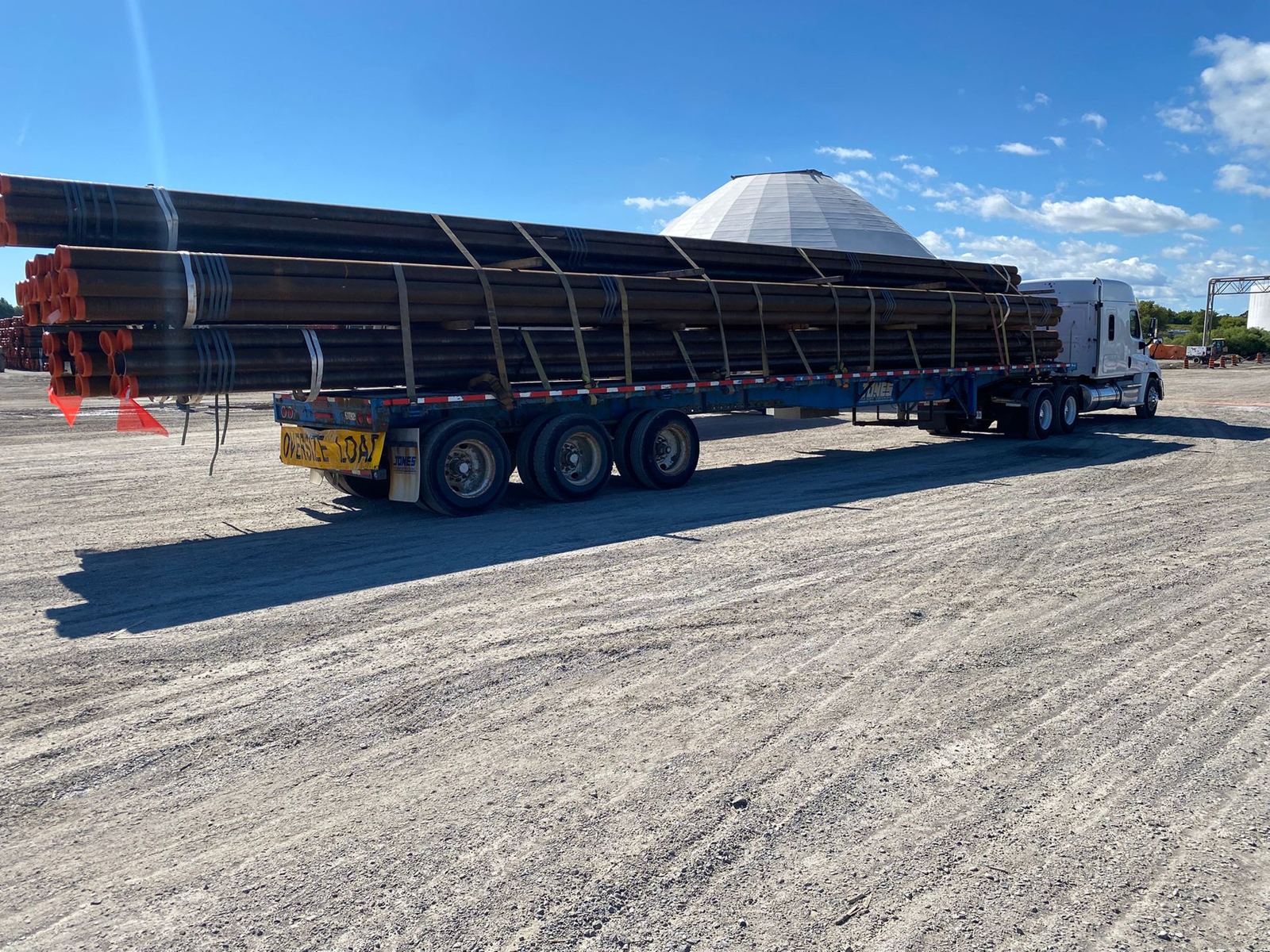 Flatbed loaded with long steel beams